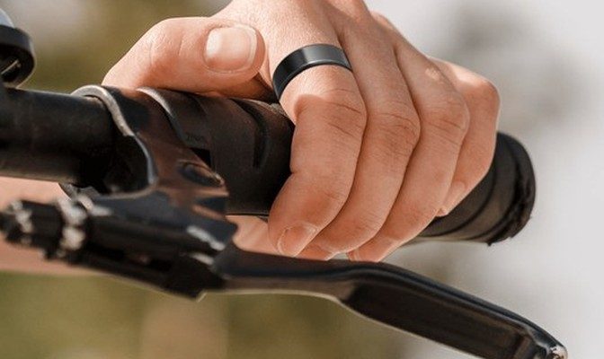 HELIOS ring on a rider's hand on the handlebars