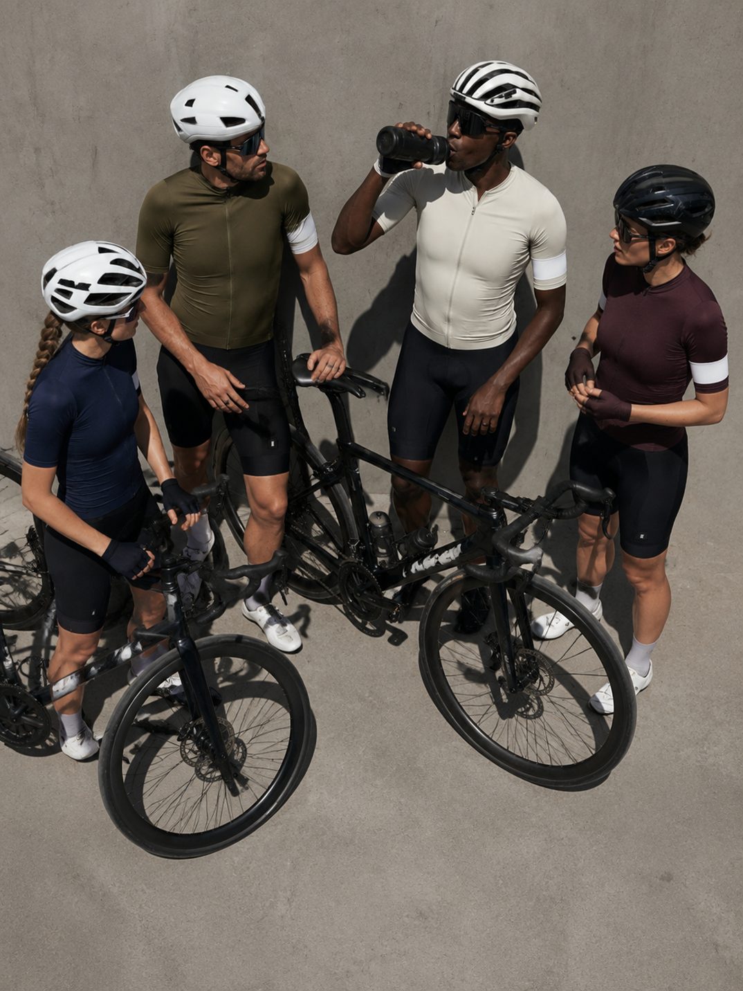 Four riders standing with their bikes
